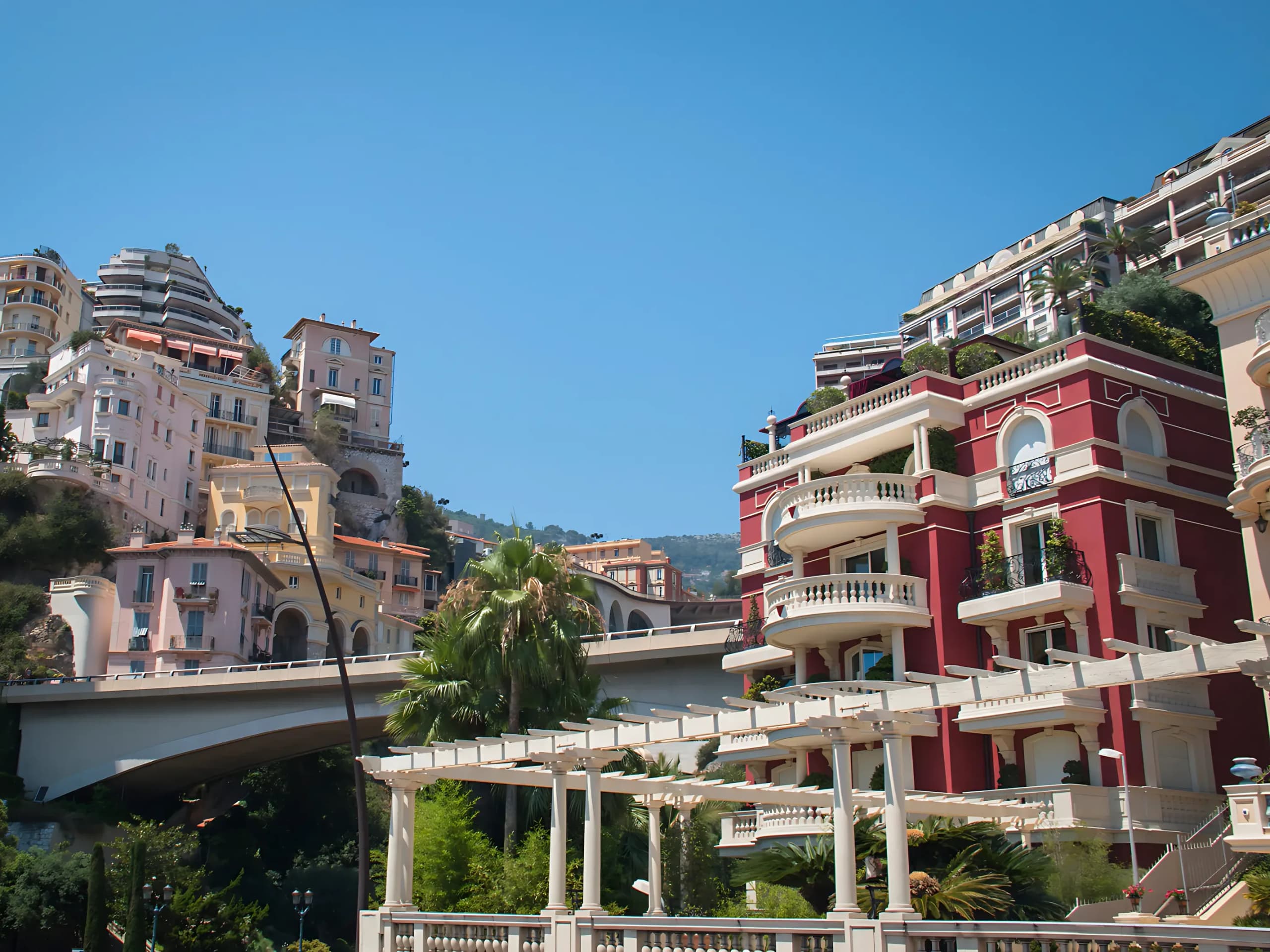 The residential slopes of Moneghetti, stepped frontages and mature planting on the hillside.