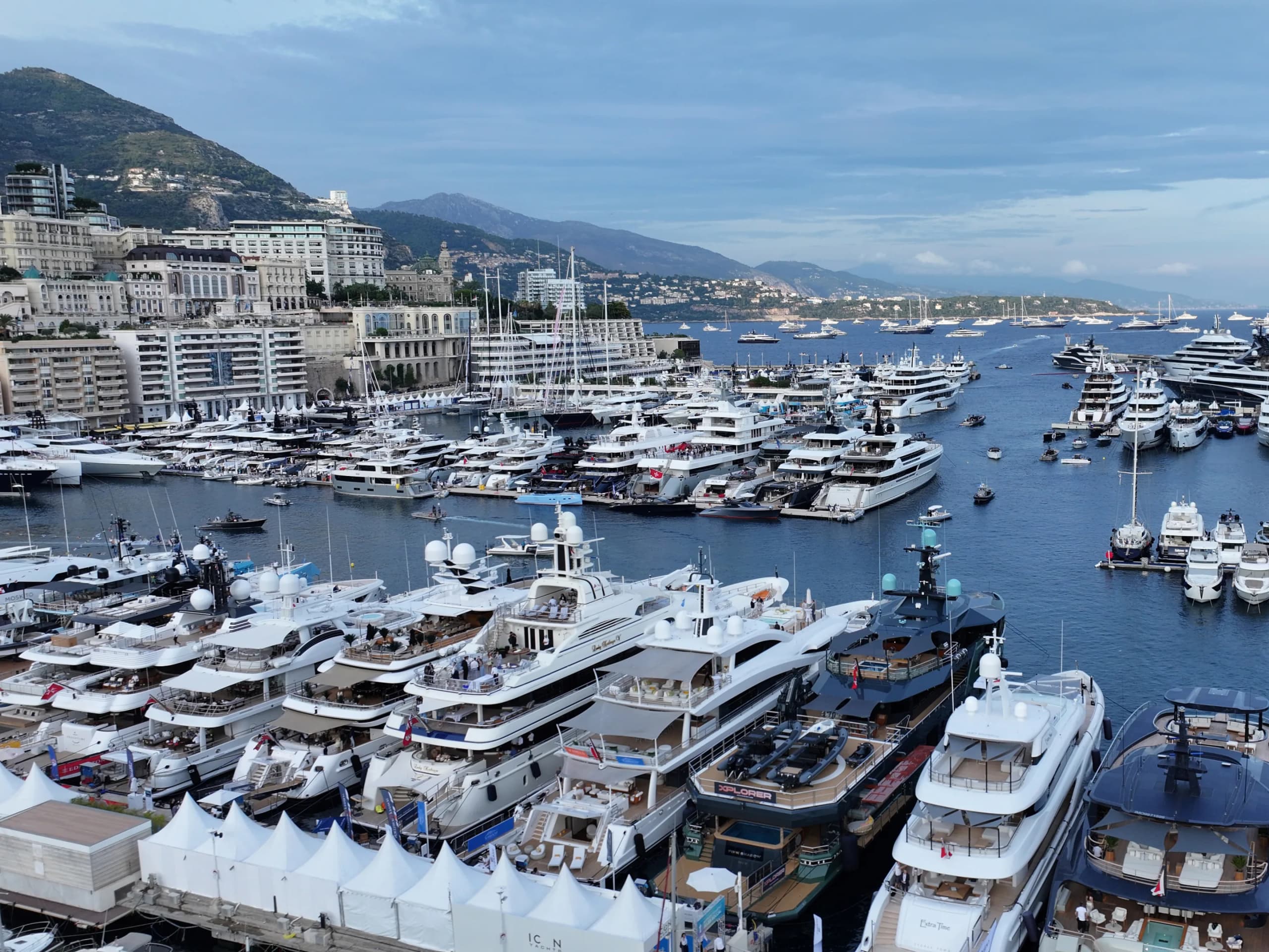 Yachts moored in Port Hercule, the terraces of the Principality stacked on the slope behind.