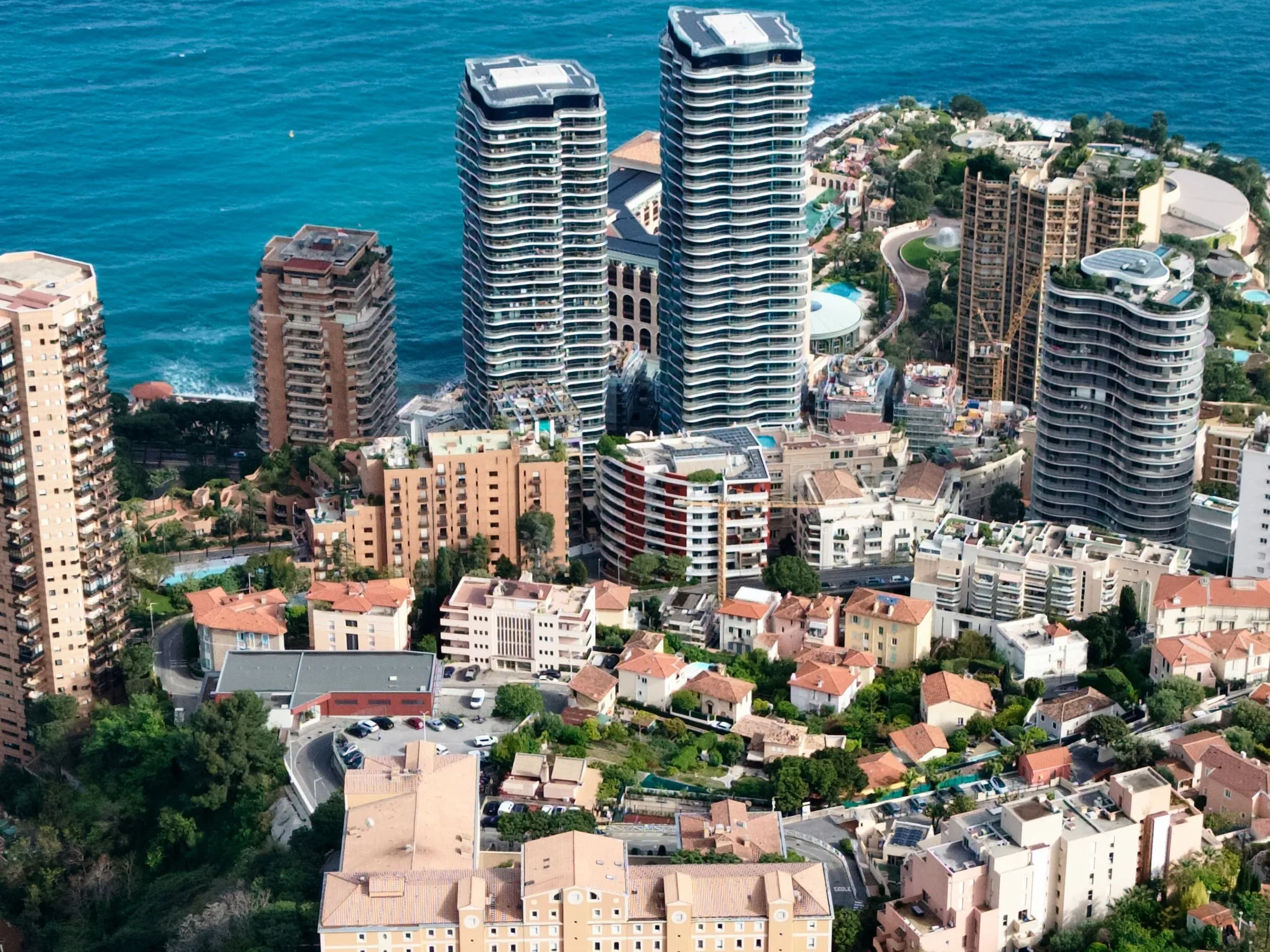 The towers of La Rousse–Saint-Roman above the sea at Monaco’s eastern edge, villas and terraces stepping down the slope below them.